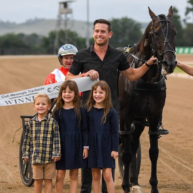 Jared Kahlefeldt celebrates Muscle Factory's win on Saturday with his children.