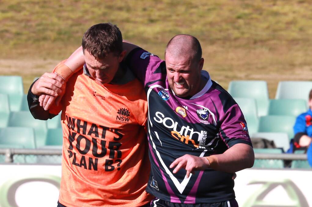 CAUSE FOR CONCERN: Mitch Curran is helped from the field after injuring his ankle in Southcity's loss to Kangaroos on Saturday. Picture: Les Smith