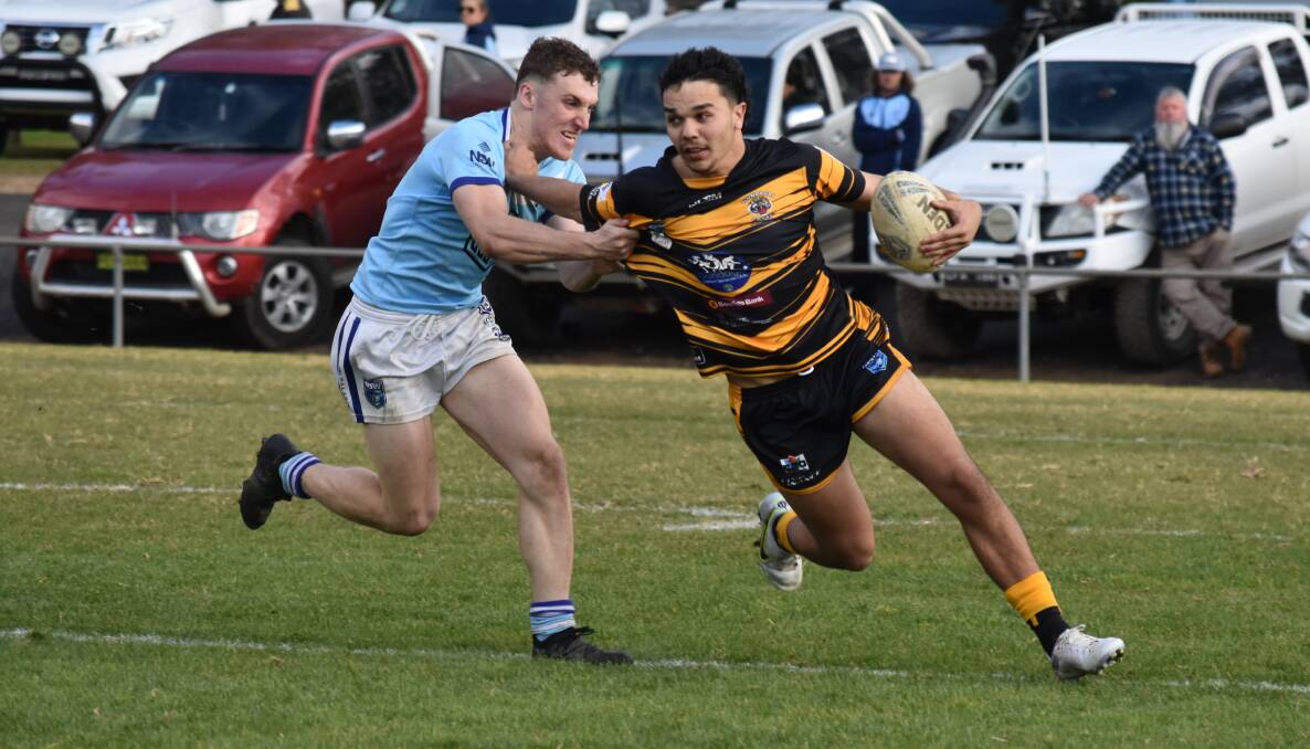 ON THE ATTACK: Latrell Siegwalt tries to push off Tom Hickson in Gundagai's dramatic win over Tumut at Anzac Park on Sunday. Picture: Courtney Rees