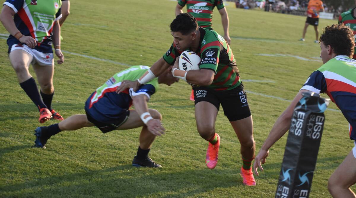 HAT-TRICK: South Sydney's Jacob Gagai pushes he way past the Group 20 Invitational defence on his way to his first of three tries. Picture: Liam Warren