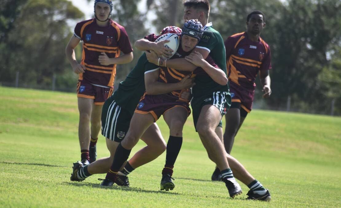 GOING NOWHERE: Jared McKinnon is wrapped up by the Western defence in Riverina's tight loss to Western in the Laurie Daley Cup at Leeton No.1 Oval on Sunday. Picture: Liam Warren
