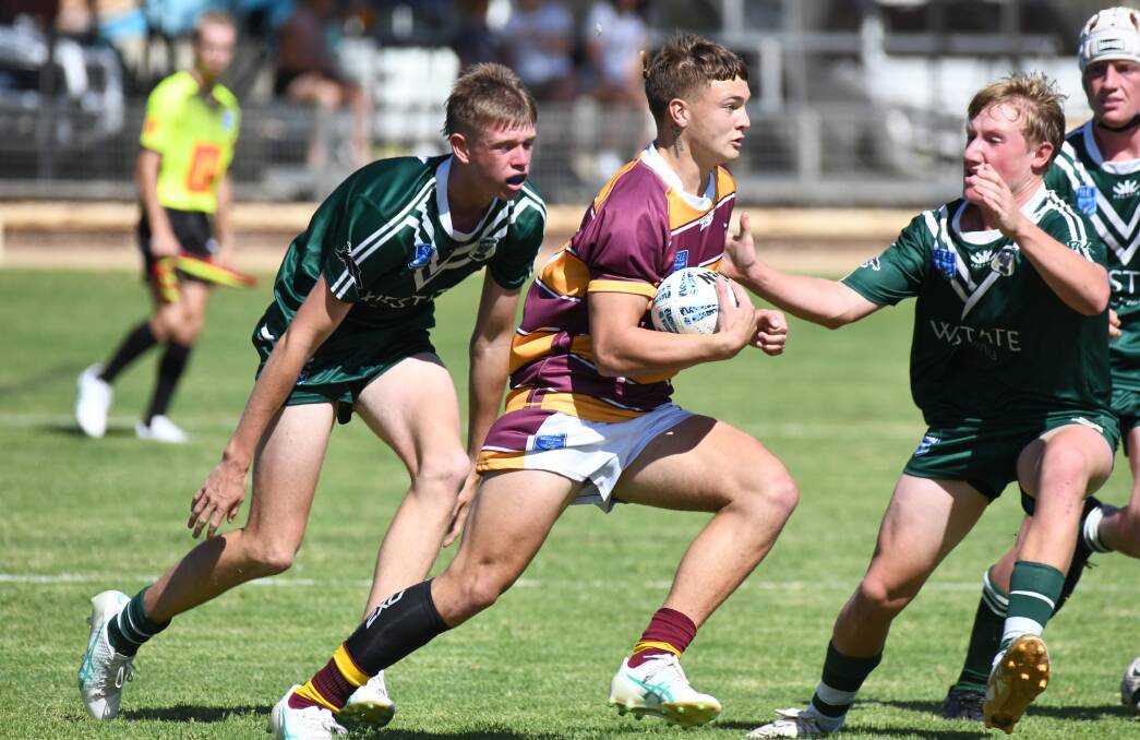 Riley Ivanku tries to avoid the Western defence in Riverina's loss in the Andrew Johns Cup clash on Sunday. Picture by Jude Keogh