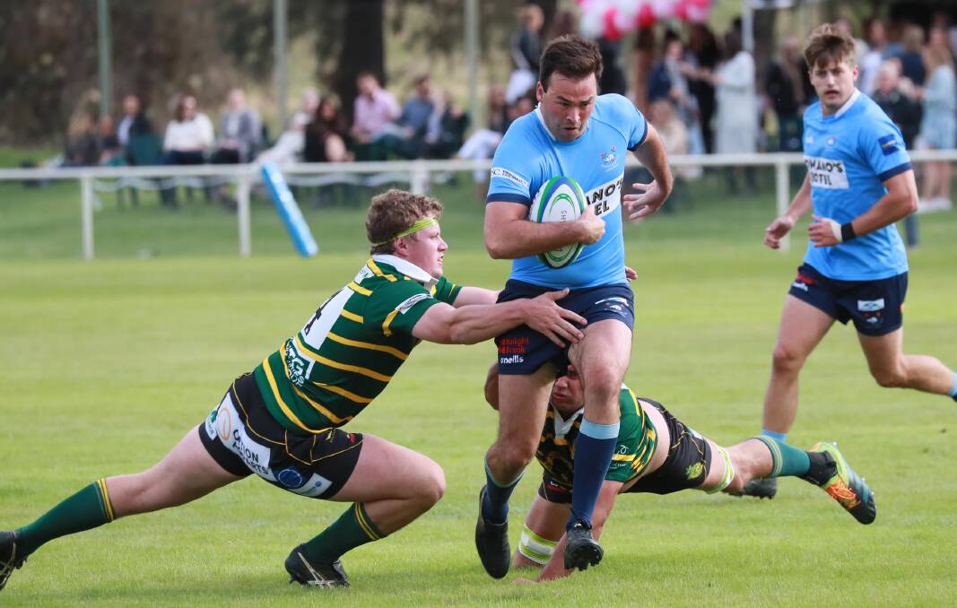 ON THE CHARGE: James Grimmett tries to break out of a tackle attempt as Waratahs proved far too strong for Ag College on Saturday. Picture: Les Smith