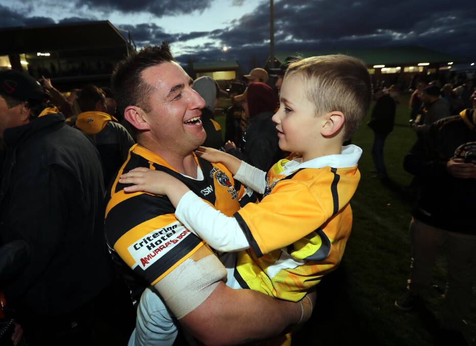 Damian Willis shares a special moment with son Harry, 5, on Saturday.