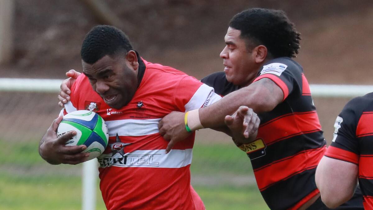 UNDER PRESSURE: Seravasoi Doli tries to break out of Jim Meya's tackle during CSU's loss to Tumut at Conolly Rugby Complex on Saturday. Picture: Les Smith