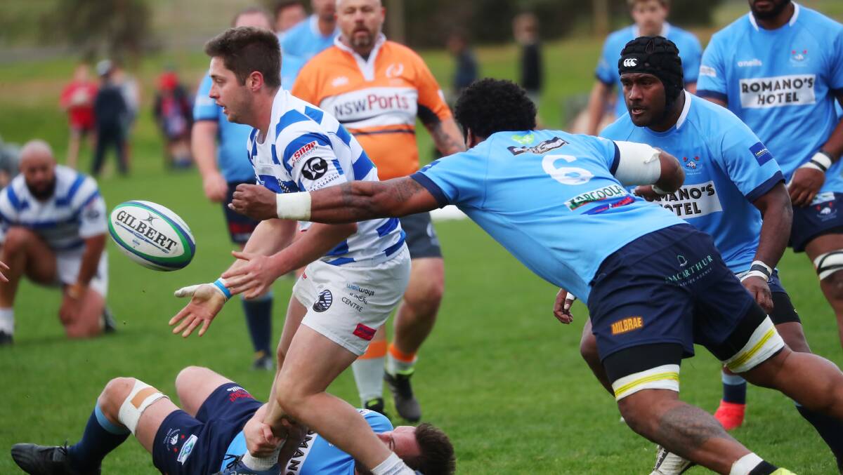 UNDER PRESSURE: Jesse Uhr sends off a pass before being tackled by Atunaisa Veiyala in Wagga City's win over Waratahs on Saturday. Picture: Emma Hillier