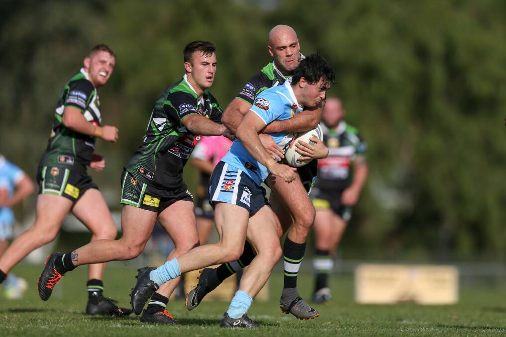 BLUE DAY: Albury captain-coach Adrian Purtell works to bring down Austin McDougall in Tumut's win at Greenfield Park on Sunday.