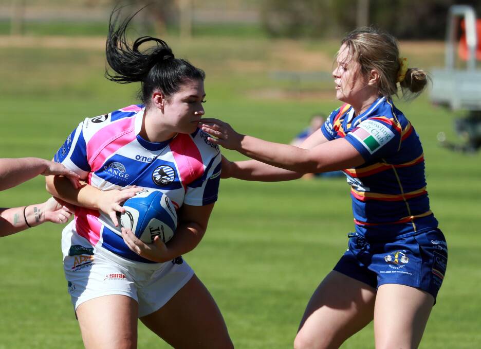 ON THE CHARGE: Marnie Lenehan looks to slip out of Megan Pearson's grasp in Wagga City's big win over Hay on Saturday. Picture: Les Smith