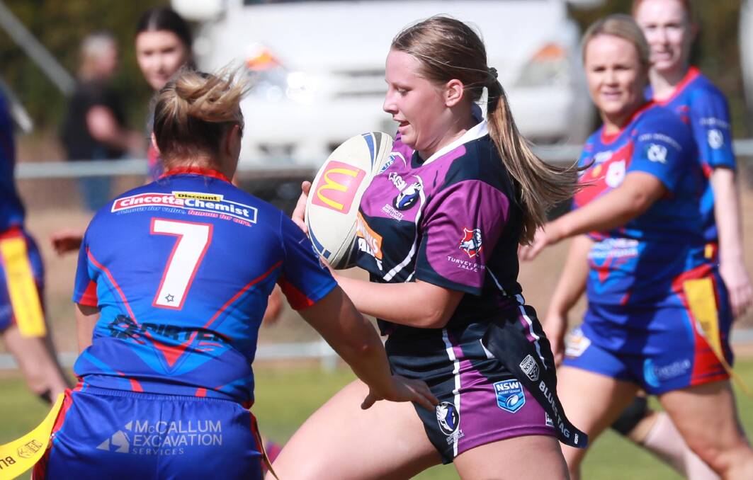 HARD TASK: Jemma Davey tries to avoid the defence of Shannon Pike in Southcity's heavy loss to Kangaroos at Harris Park.