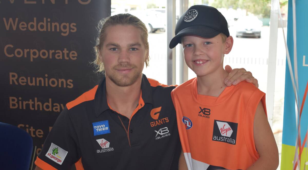 MEETING AN IDOL: Finn Parker, 9, shares a moment with GWS player Harry Himmelberg wearing a jumper with the Wagga product's number on his back on Wednesday. Picture: Courtney Rees