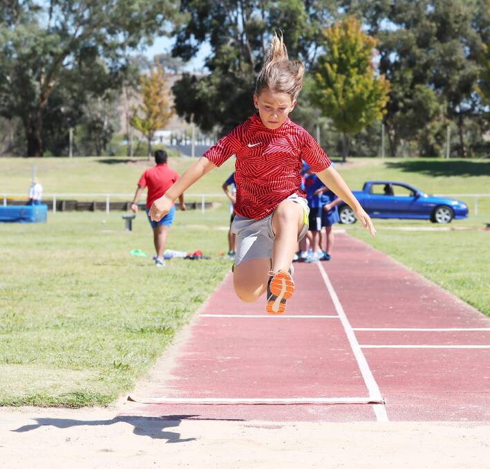 AIRBOURNE MAGIC: Riley Knight, 11, launches into the long jump pit during the St Joseph's athletics carnival at Jubilee on Friday. Picture: Kieren L Tilly