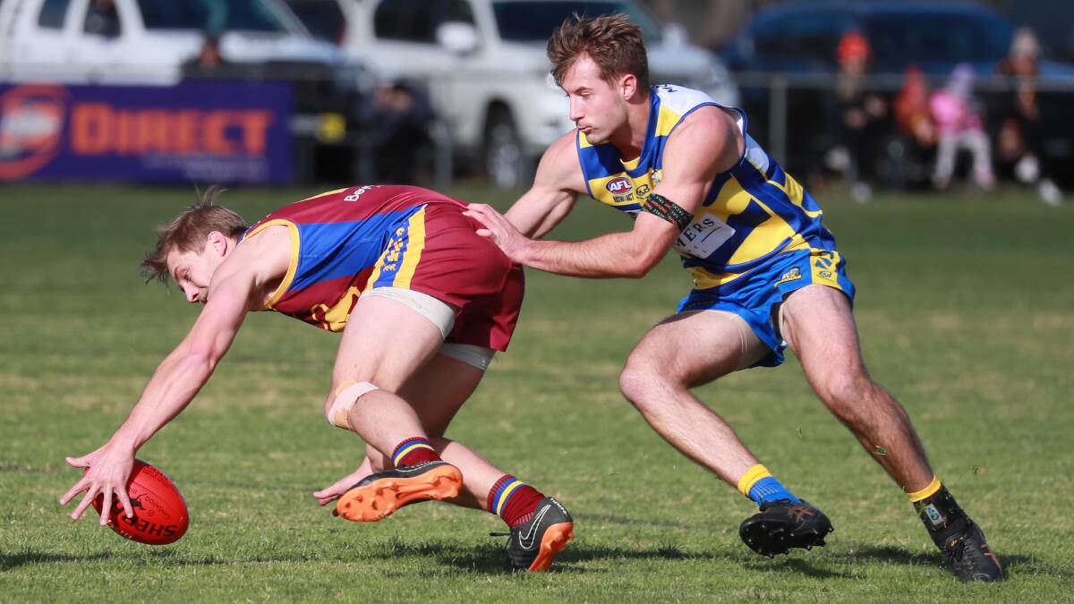 TOUGH GET: Rhys Hartwig tries to control the ball under pressure from George Kendall as Mangoplah-Cookardinia United-Eastlakes won the battle on the two undefeated teams on Saturday. Picture: Les Smith