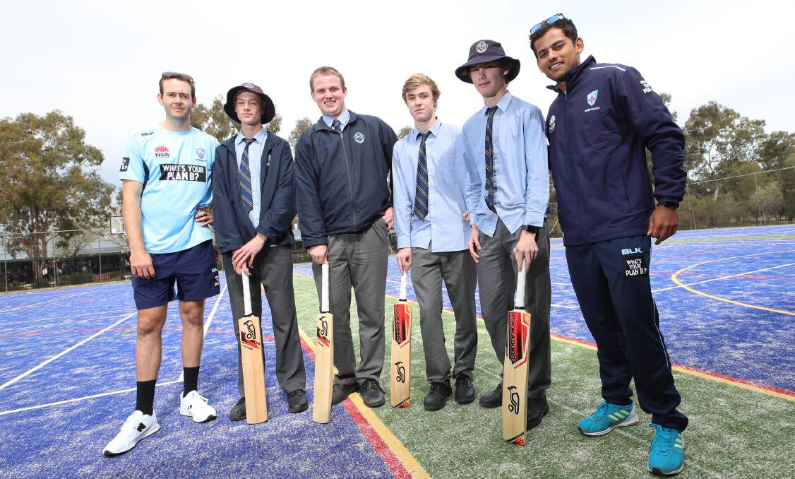 HELPING HAND: NSW players Kurtis Patterson (left) and Param Uppal (right) with Mater Dei Catholic College students Jacob Ferguson, Nathanael Mooney, Kyle Hockley and Louis Grigg as part of Cricket NSW Country Blitz on Thursday. Picture: Les Smith