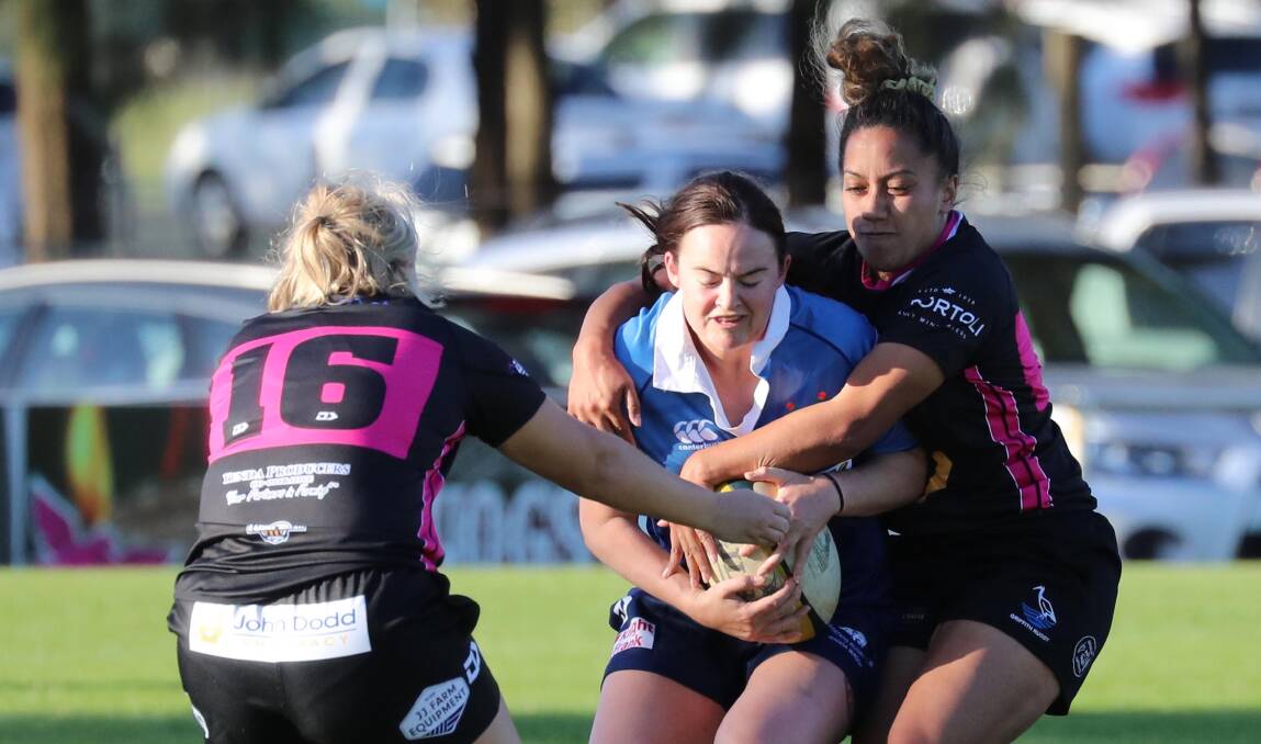 WRAPPED UP: Rebecca Hill and Amelia Lolotonga work to bring down Gabi Hammond in Griffith's win over Waratahs at Conolly Rugby Complex on Saturday. Picture: Les Smith