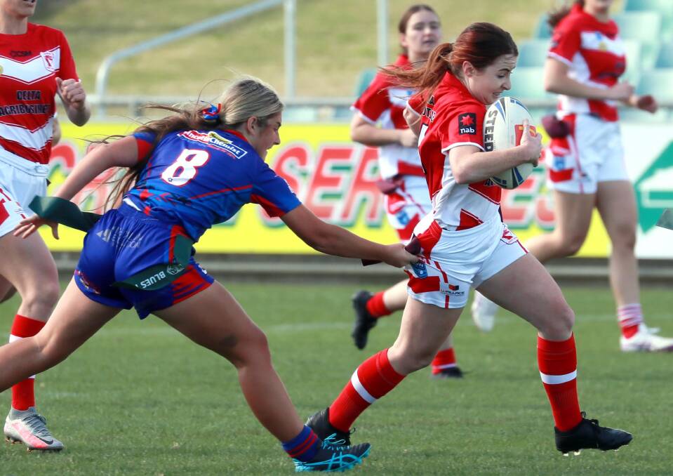 HITTING BACK: Temora's Ashton Taylor tries to escape Milly Lucas defending as the Dragons scored a 14-6 win over Kangaroos at Equex Centre. Picture: Les Smith