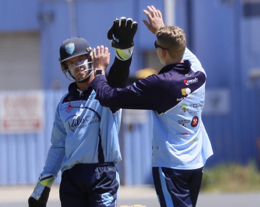 Brayden Ambler and Jake Scott celebrate a wicket in South Wagga's win.