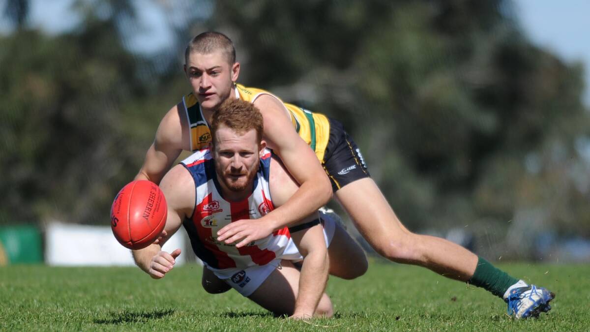 HARD AT IT: Ag College's Karl Hicken and CSU's Daniel Perri battle for the ball during the charity Aussie rules game at Peter Hastie Oval on Saturday. Picture: Laura Hardwick
