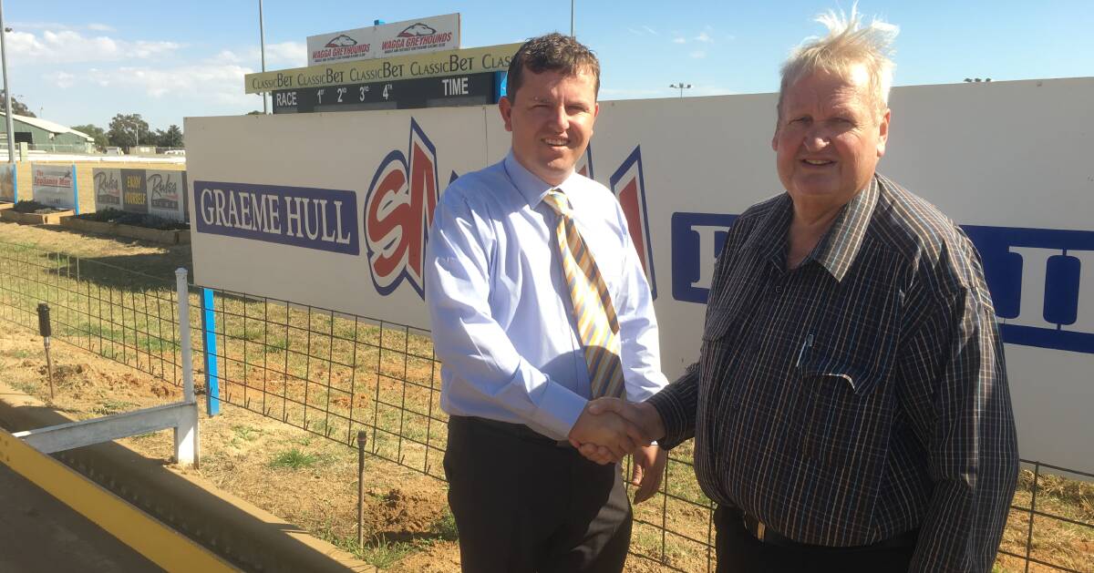FRESH START: President Maurice Finemore (left) congratulates John Patton on his new role as Wagga Greyhound Racing Club's racing manager. Picture: Courtney Rees