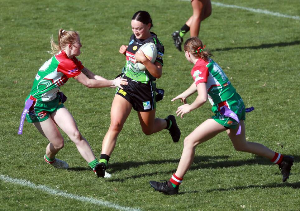 MAKING SPACE: Alesha Willcox tries to split the defence of Bridget Horsley and Ella Clark during Albury's loss to Brothers on Saturday. Picture: Les Smith