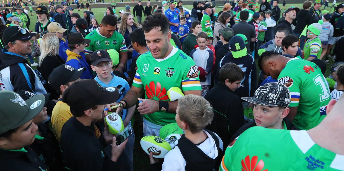 FAN FAVOURITE: Canberra Raiders centre Michael Oldfield and teammatesare swarmed by fans at Equex Centre after their win Penrith on Saturday night. Picture: Emma Hillier