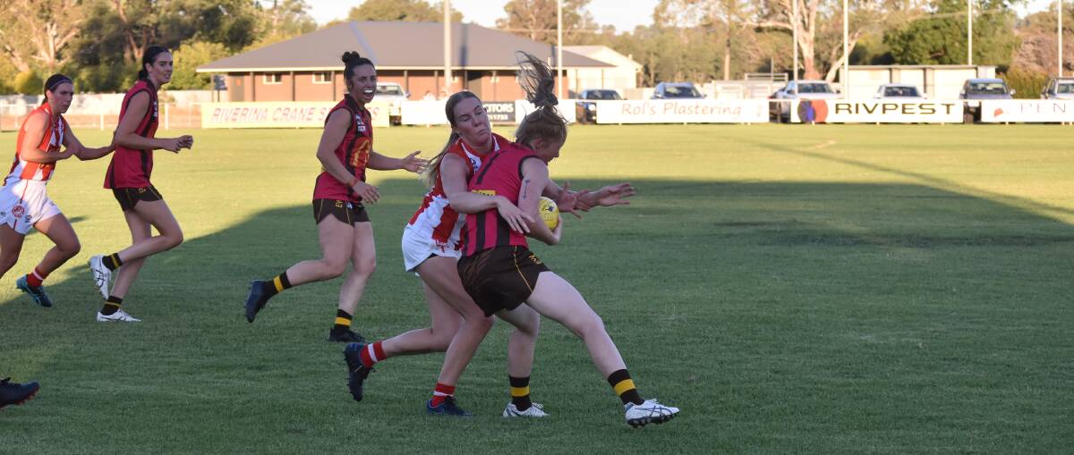 GOING NOWHERE: Alexandra Bulle tries to wrap up Bridget Horsley as Charles Sturt University extend their unbeaten start to the season against East-Wagga Kooringal at Gumly Oval on Friday. Picture: Courtney Rees