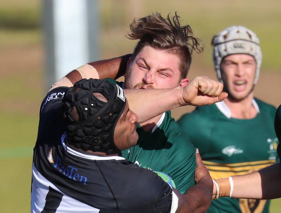 STEAMING AHEAD: Ag College forward Luke Turner tries to force off Apimeleki Kaloudonu in their win at Beres Ellwood on Saturday. Picture: Les Smith
