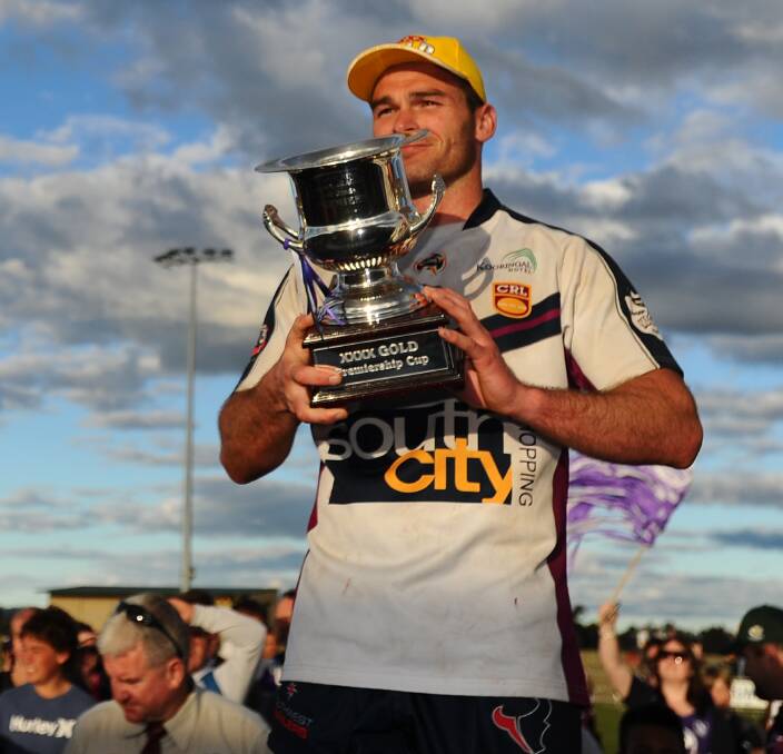 HAPPY MEMORY: Former Southcity and Temora captain-coach Daniel Fitzhenry, lifting the Group Nine premiership cup in 2011, is moving away from Wagga after six seasons in the city.