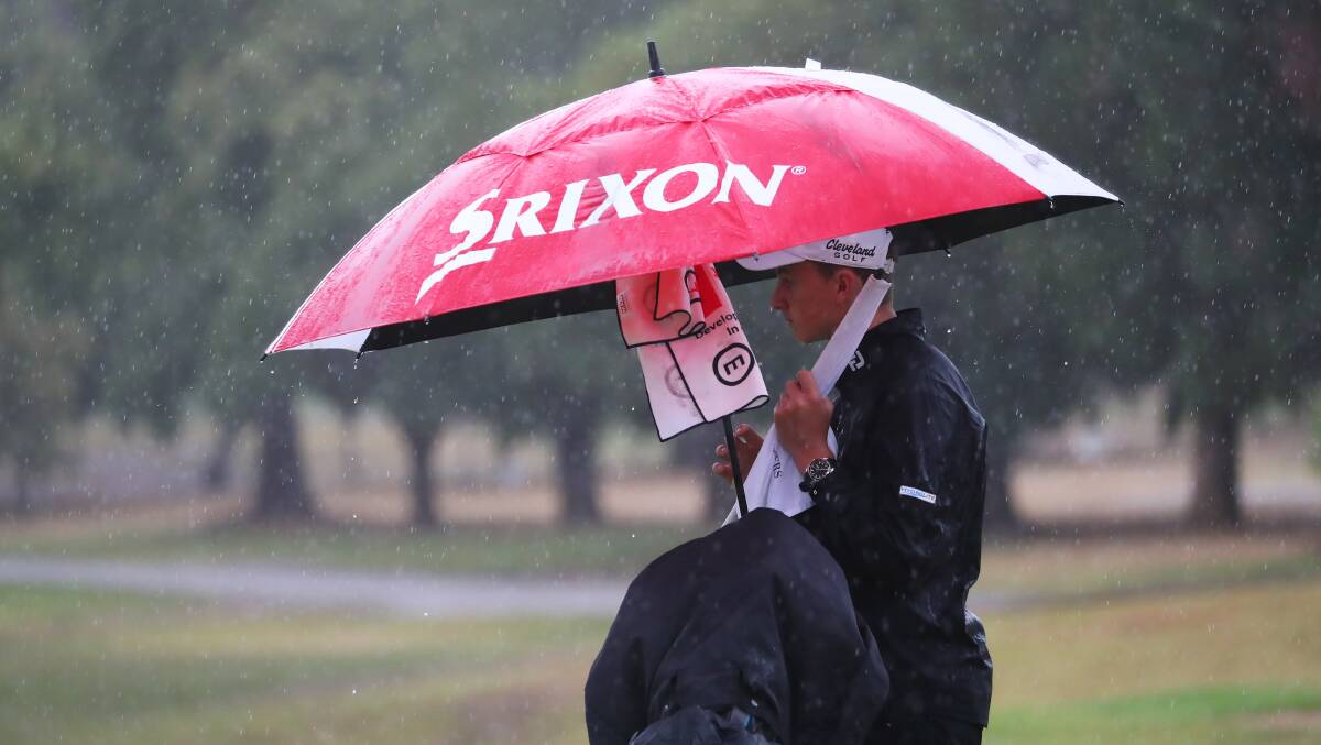 TOUGH CONDITIONS: Bart Carroll tries to keep dry before the second round of the Wagga Country Club championships were abandoned on Sunday. Carroll is one of five-joint leaders heading into the final weekend.