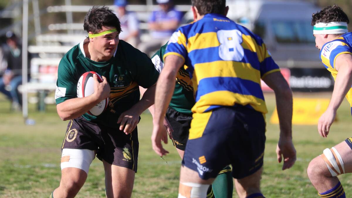 CHARGING AHEAD: Duncan Woods brings the ball forward in Ag College's preliminary final win on Saturday. He's looking to down Waratahs in his final game with the club in the grand final.