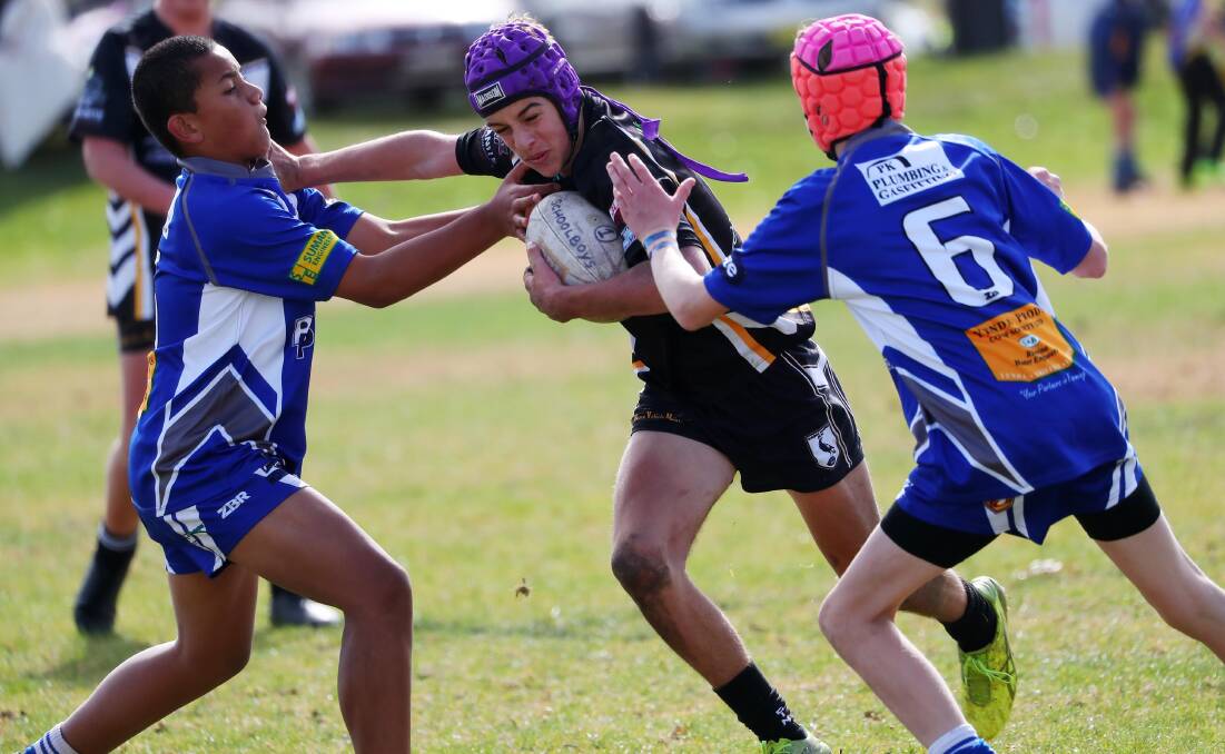 Luke Lawrence tries to push off the Yenda defence during a under 14s game for Wagga Magpies at the Riverina Schoolboys Carnival on Saturday. Picture: Emma Hillier
