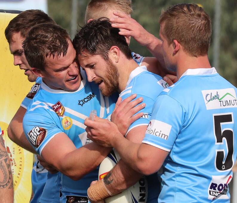 Ben Roddy celebrates with Lachlan Bristow after one of his three tries in the grand final.