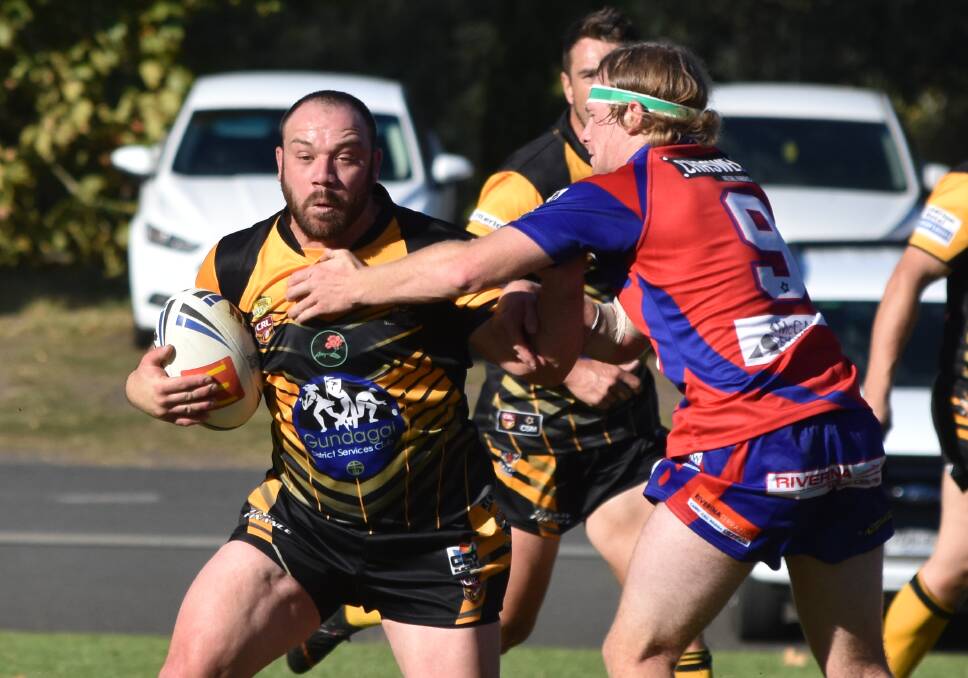 BUILDING MOMENTUM: Brock Dunn tries to shrug out of Hudson Frazier's tackle attempt during Gundagai's win over Kangaroos on Sunday. Picture: Courtney Rees