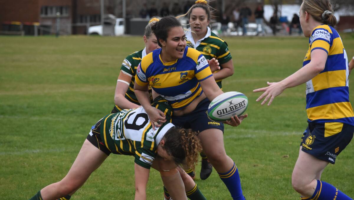 Veniana Tuicake gets the ball away under pressure from Elizabeth Curline in Albury's 77-5 loss to Ag College on Saturday. Picture: Courtney Rees