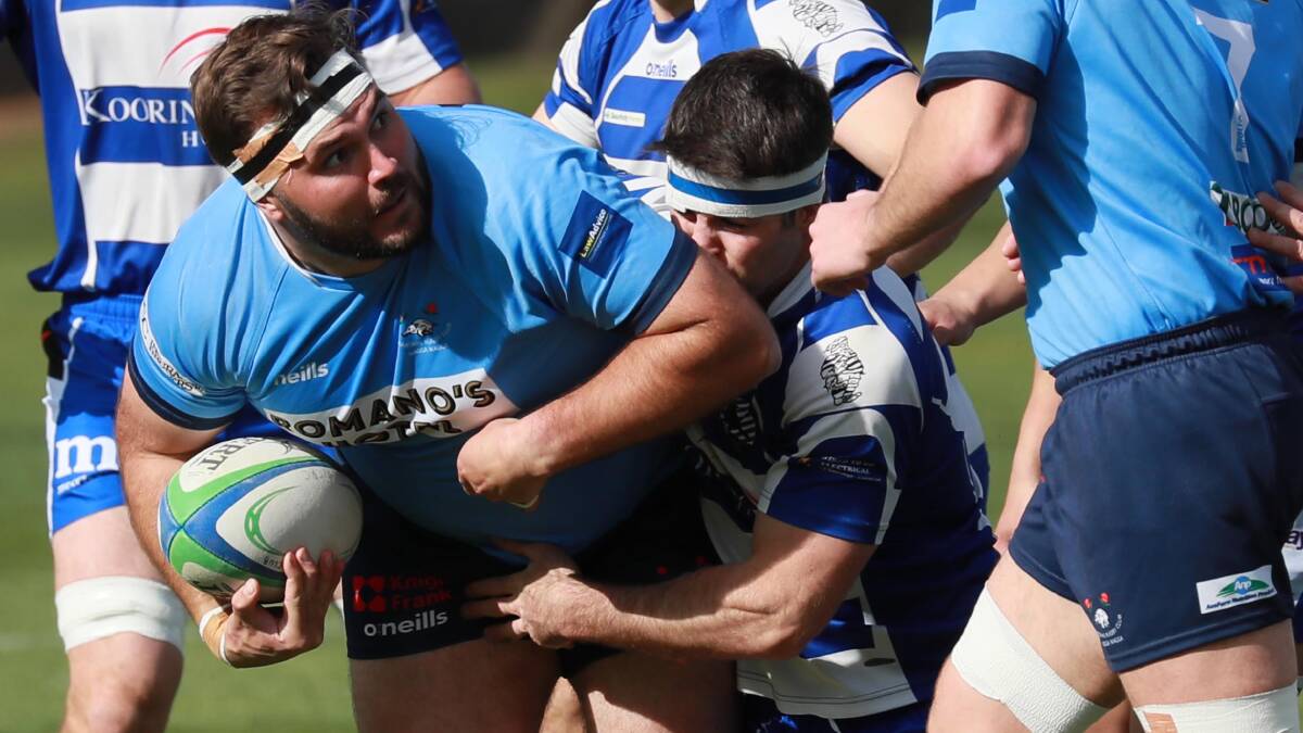 Ron Wiltshire gets brought down by Rory Sheard in the last clash between Waratahs and Wagga City.