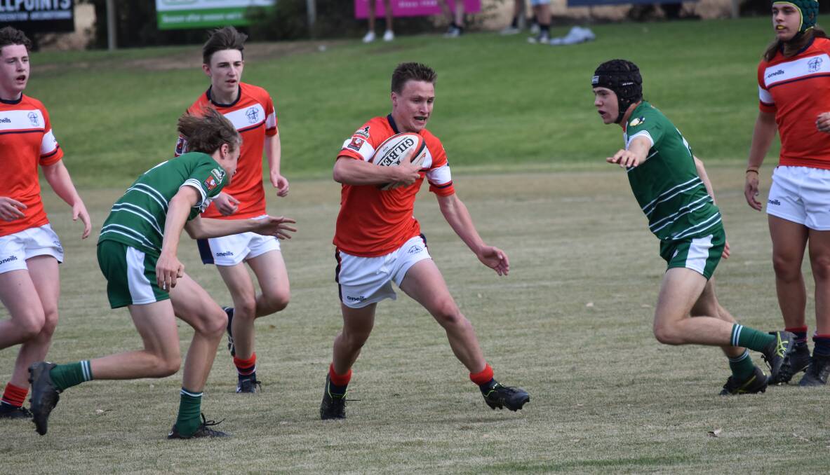 MAKING INROADS: Kildare Catholic College's Ned Cooper tries to split the TRAC defence in his side's win in the Super Sixes at Conolly Rugby Complex on Thursday. Picture: Courtney Rees