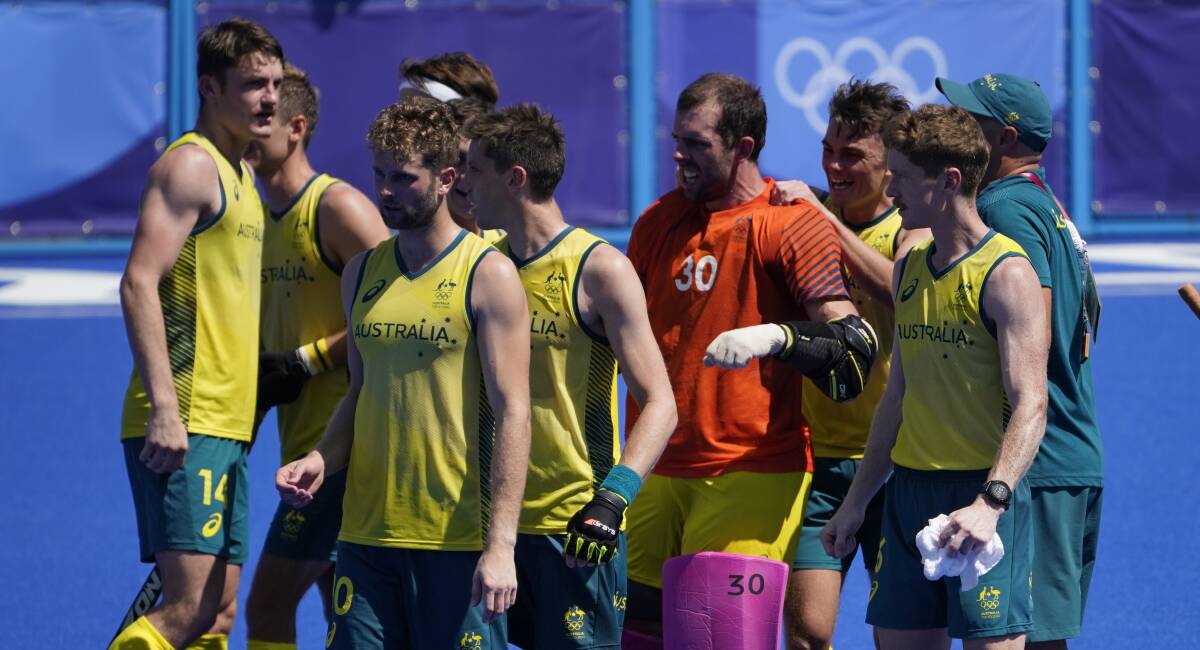 STAYING ALIVE: Dylan Martin (left) celebrates with his Kookaburra teammates after they secured their place in the semi-finals after a shootout win over The Netherlands on Sunday. Picture: AP Photo/John Minchillo 