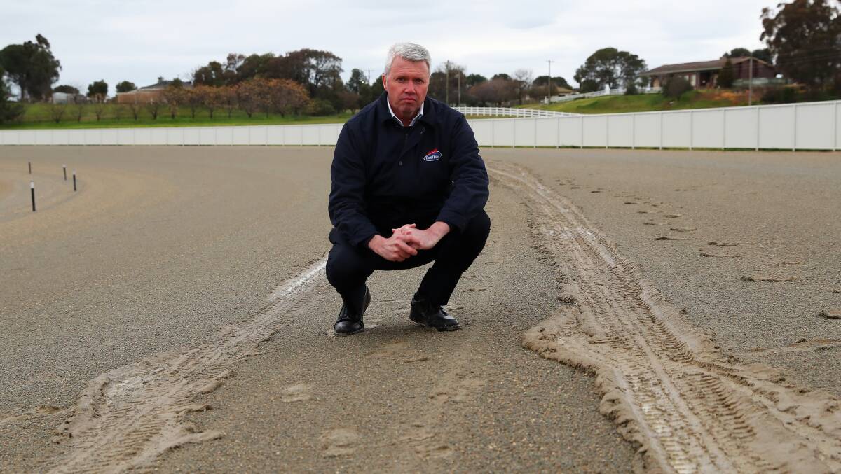 SLICK SURFACE: Wagga Harness Racing Club chief executive Graeme White inspects the damage left on the Riverina Paceway surface following an attempt to test the mobile on Friday. Picture: Emma Hillier