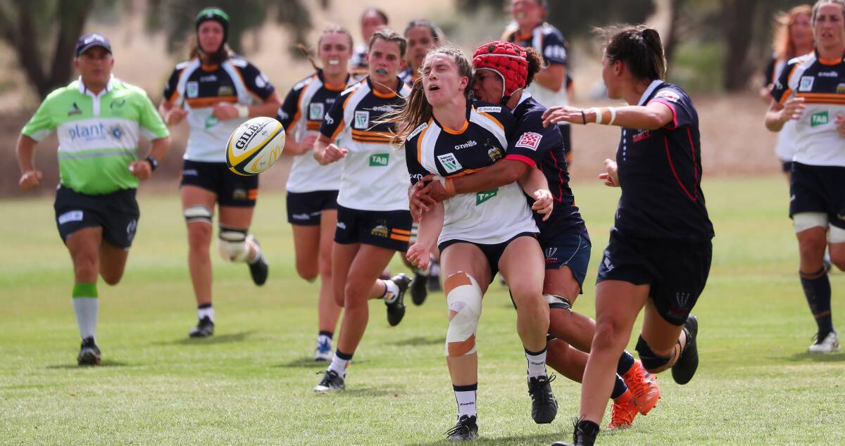 CRUNCH TIME: Ella Ryan cops a hit
after sliding out a pass during the first
of two ACT Brumbies Super W trials
against Melbourne Rebels at Paramore Park
on Saturday. Picture: Emma Hillier