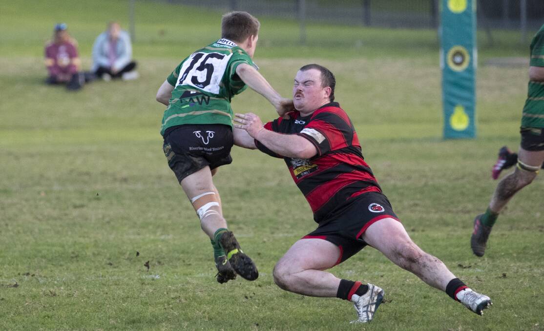 MISMATCH: Will Kingwill tries to bring down Jack Wood in Tumut's tight win over Ag College at Beres Ellwood Oval. Picture: Madeline Begley