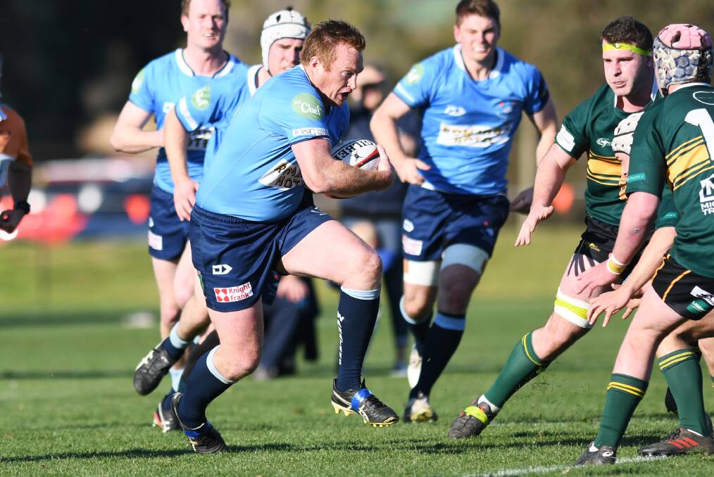 CHARGING AHEAD: Waratahs captain Tim Corcoran brings the ball forward as his side booked another grand final appearance with a big win over Ag College on Saturday.