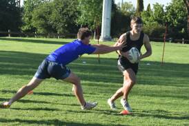 Jude Cattle tries to reach Riley Ivanku at the Canberra Raiders Academy at Beres Ellwood Oval on Monday. Picture by Courtney Rees