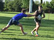 Jude Cattle tries to reach Riley Ivanku at the Canberra Raiders Academy at Beres Ellwood Oval on Monday. Picture by Courtney Rees