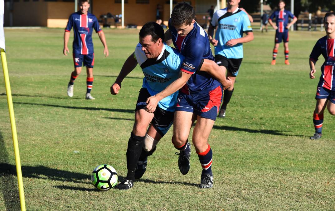 TIGHT CONTEST: Adam McPhail and Chris Oczkowski battle for the ball during Henwood Park's 2-1 win over Cootamundra on Sunday. Picture: Courtney Rees
