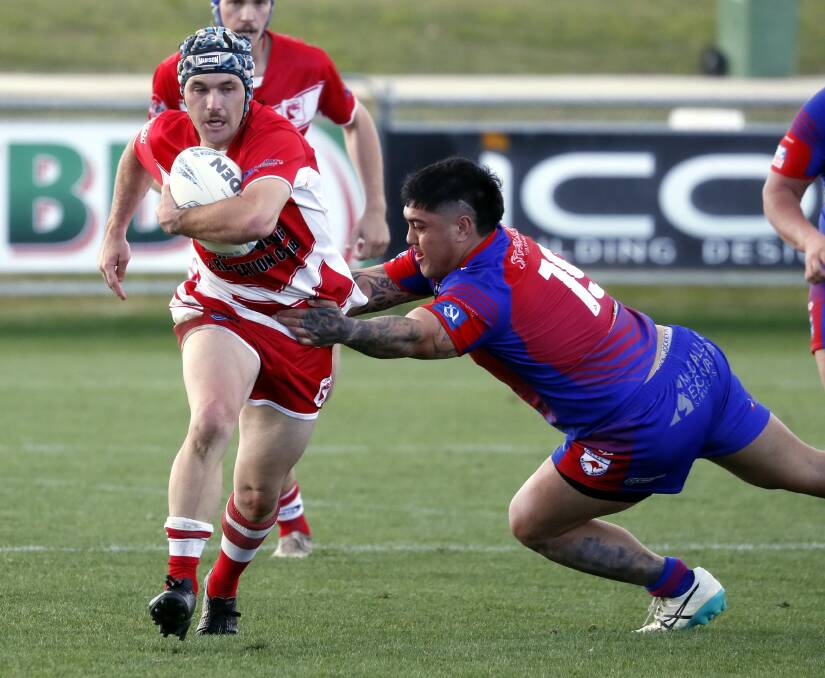 GOOD START: James Stewart, who scored two tries in Temora's win over Kangaroos, tries to break out of Dakota Ruta's tackle attempt at Equex Centre on Saturday. Picture: Les Smith