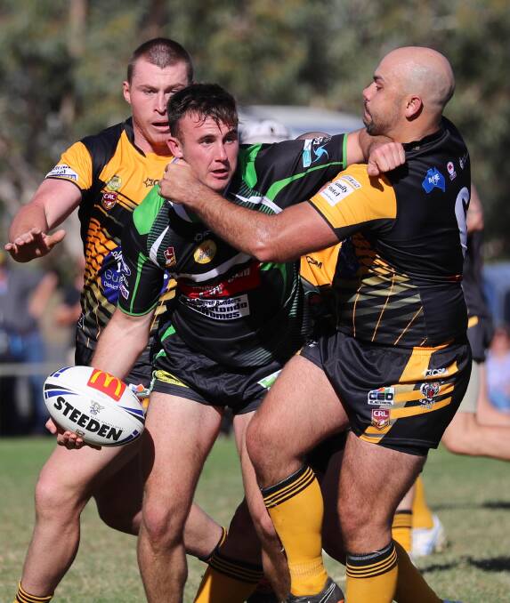BIG MOMENT: Liam Wiscombe looks to get an offload away despite Blake Dunn's tackle attempt before going on to score the last try in Albury's draw with Gundagai on Sunday. Picture: Les Smith