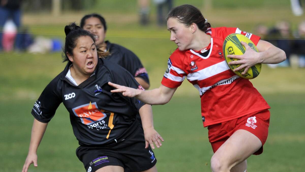 SNEAKING AWAY: Ellen McIntyre tries to fend off Sophie Welsh during CSU's big win over Griffith in the women's sevens major semi-final on Saturday. Picture: Chelsea Sutton