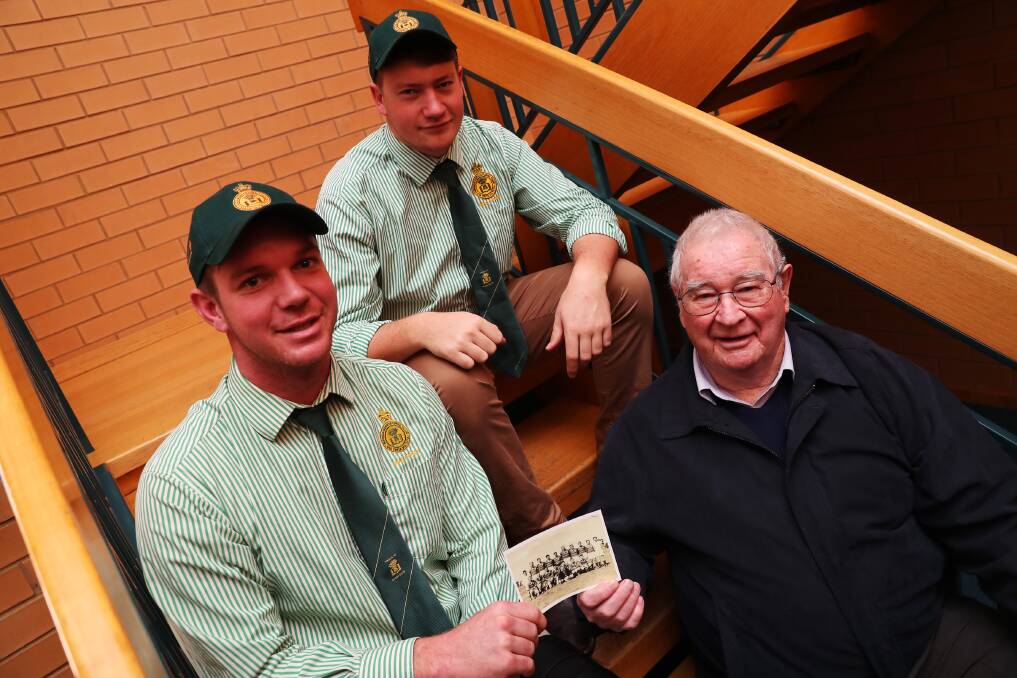 CLUB HISTORY: Current day Ag College Ethan Brien, Kellen Lemesurier receive a piece of history from member of the 1949 side Donald Erickson. Picture: Emma Hillier