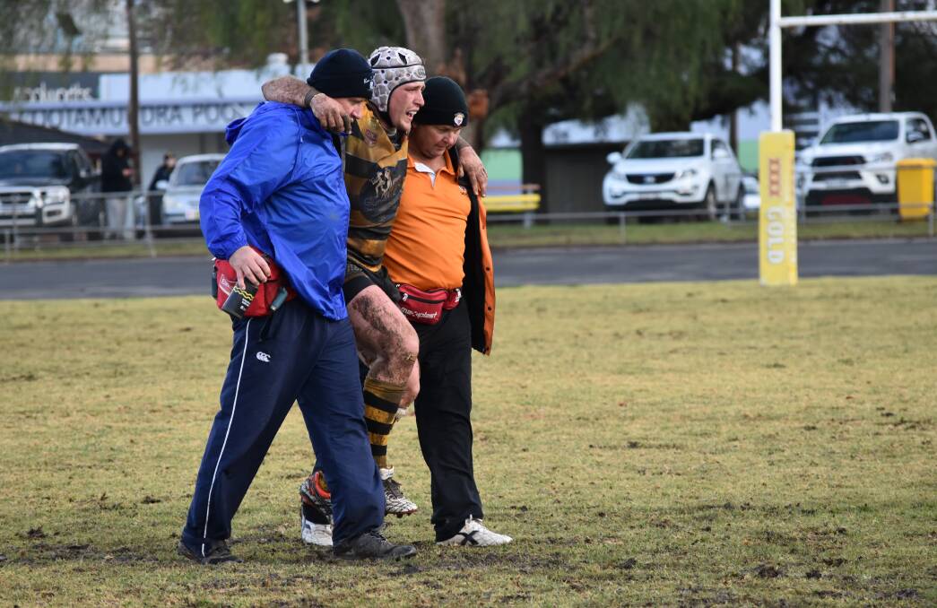 BIG WORRY: James Luff is helped off the field after injuring his knee in Gundagai's win over Cootamundra at Les Boyd Oval on Saturday. Picture: Courtney Rees