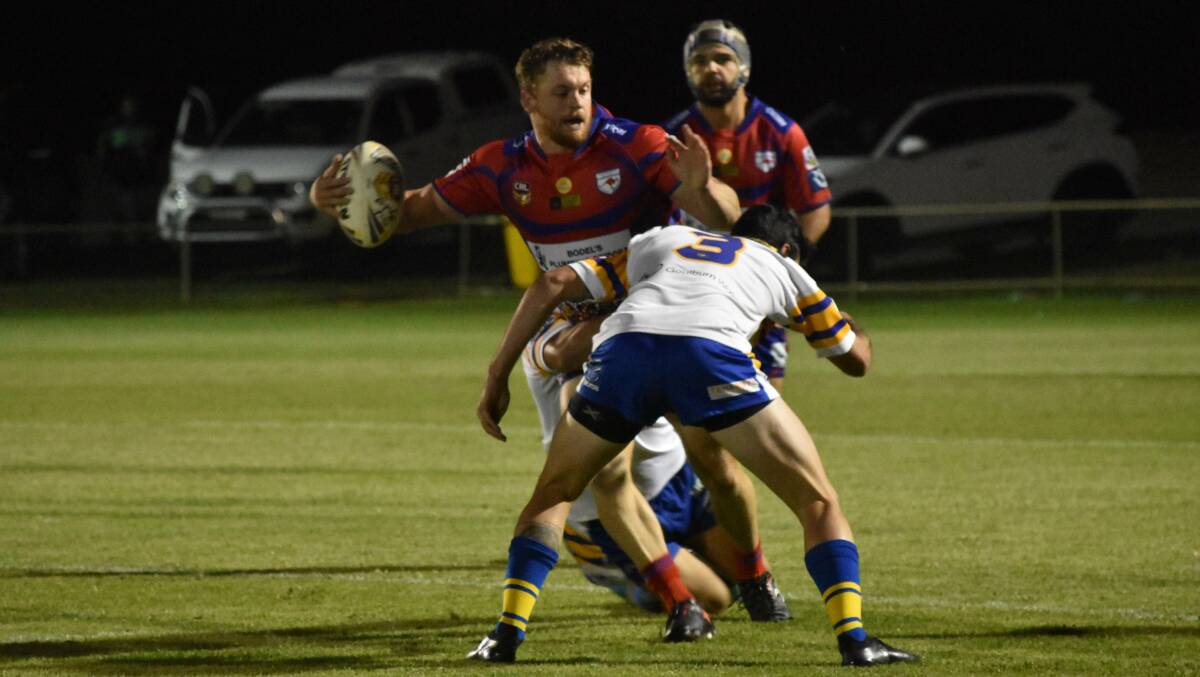 LOOKING FOR OPTIONS: Hayden Jolliffe tries to get a pass away as Kangaroos started their season with a loss to Goulburn in the West Wyalong Knockout on Friday. Picture: Courtney Rees