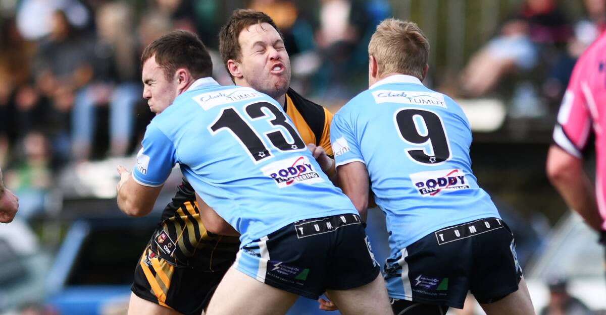 Lewis Arragon and Jacob Toppin look to stop Cameron Woo in Gundagai's win over Tumut on Sunday.
